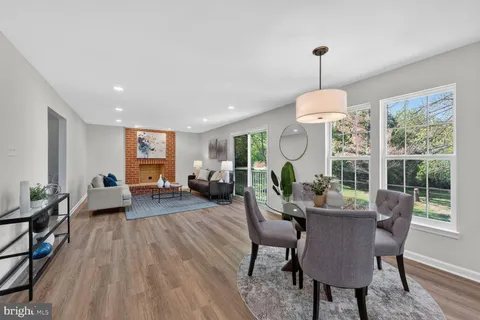 a living room with furniture chandelier and a large window