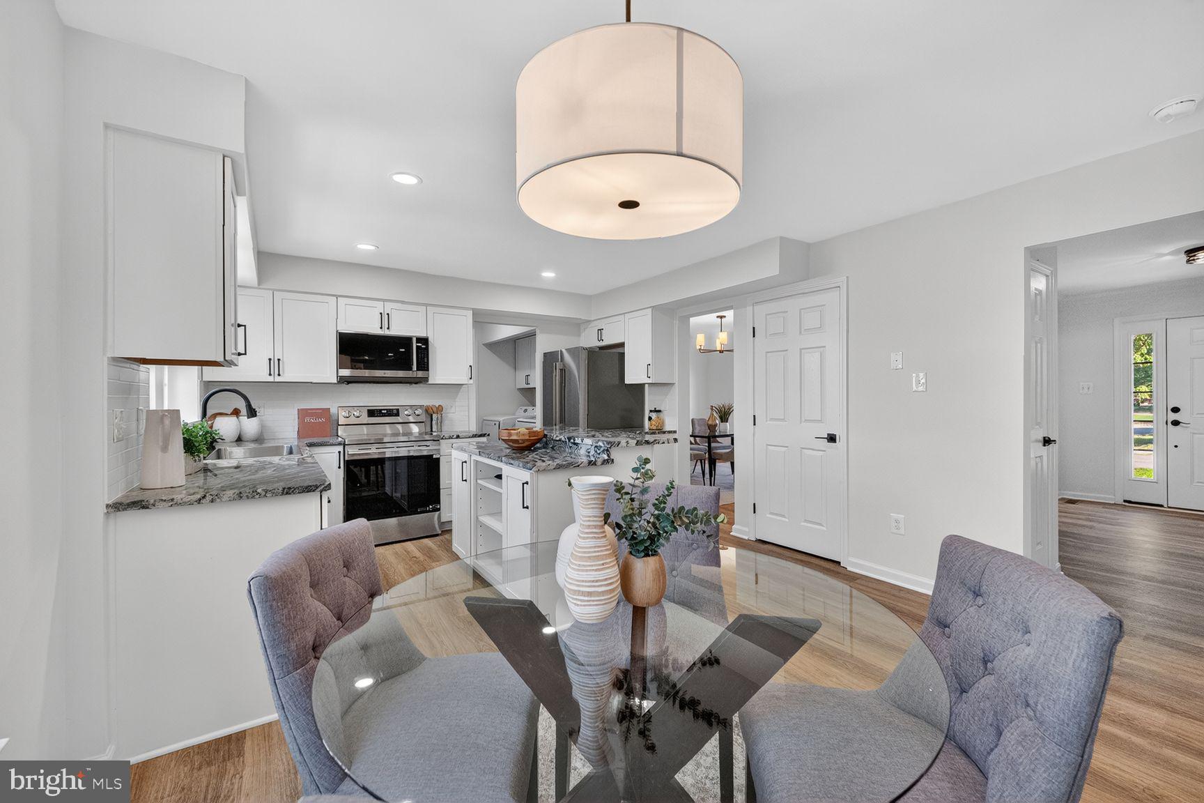 2339 Colts Brook Drive Reston, VA 20191 - Photo 16 of 51 a living room with furniture a fireplace and a dining table with wooden floor