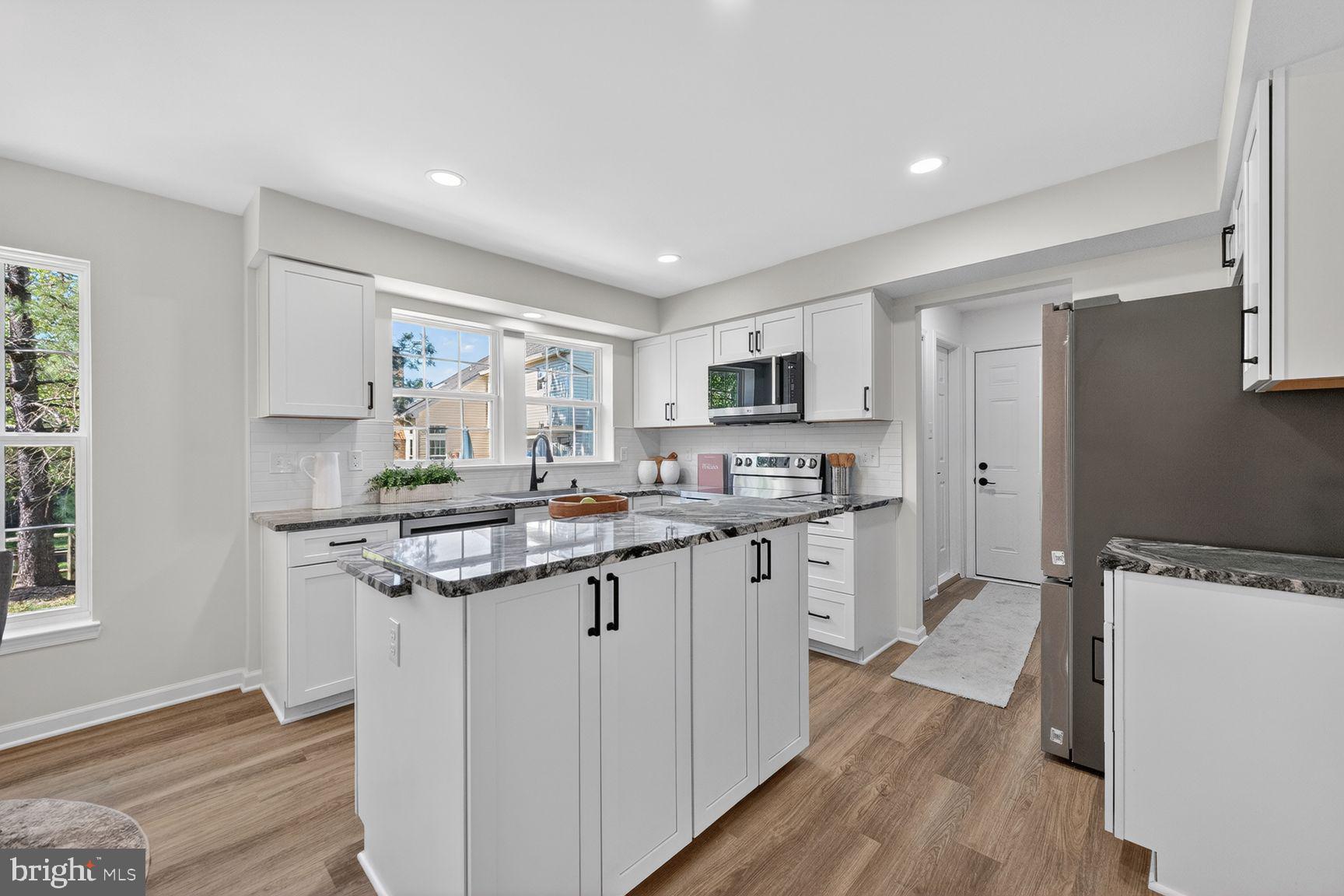 2339 Colts Brook Drive Reston, VA 20191 - Photo 19 of 51 a kitchen with a sink stove and cabinets
