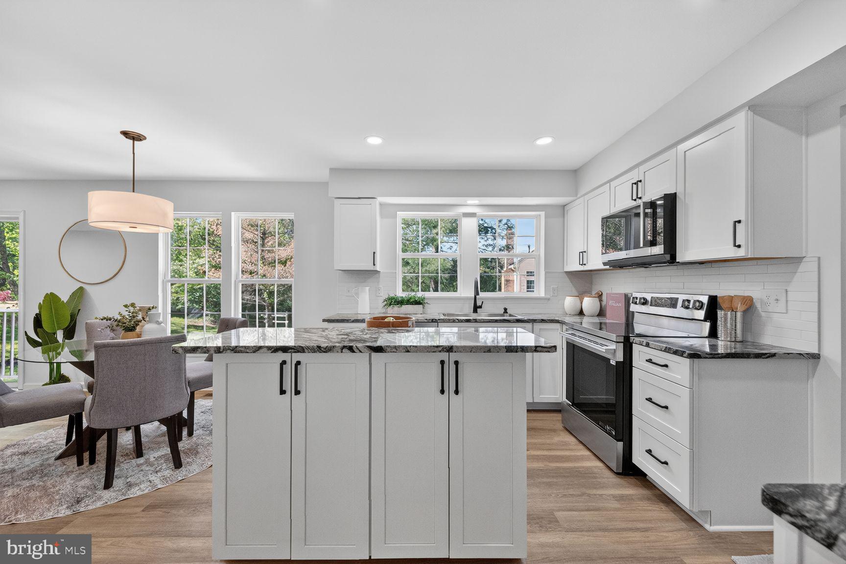 2339 Colts Brook Drive Reston, VA 20191 - Photo 20 of 51 a kitchen with lots of counter space dining table and stainless steel appliances