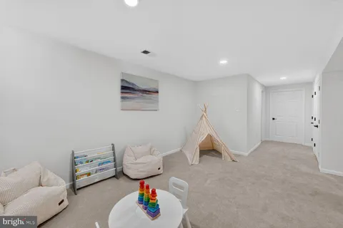 a view of a hallway with seating area