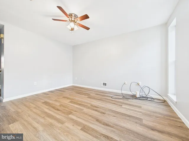 a view of a room with a ceiling fan