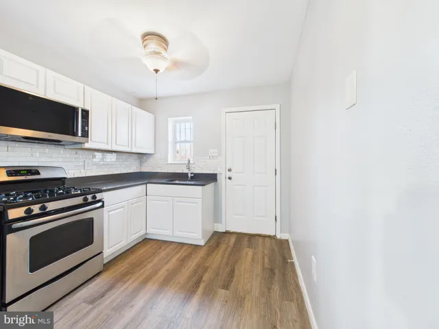 a kitchen with wooden floors and a stove