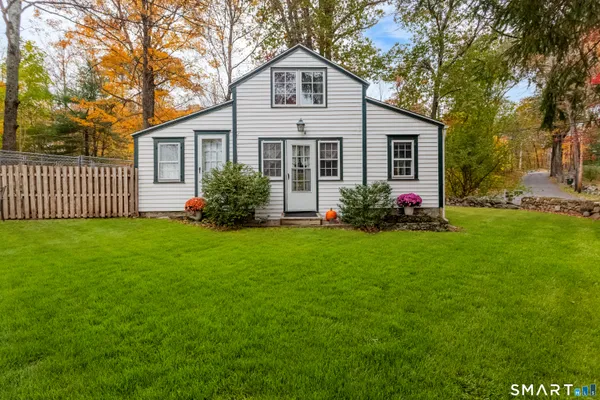 a front view of house with yard and green space