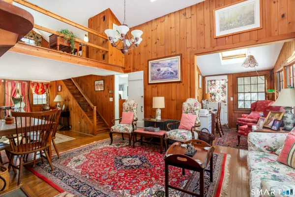 a living room with furniture a rug and a table