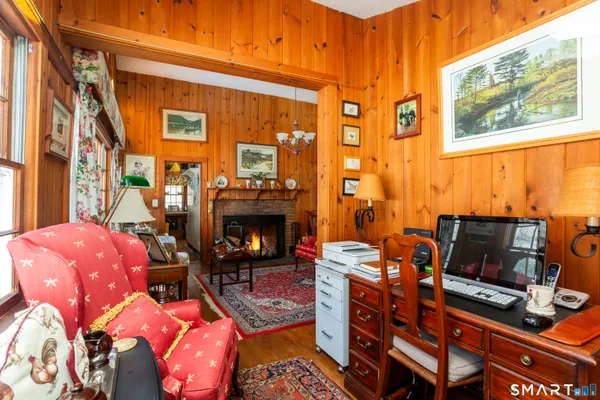 a living room with furniture a fireplace and next to a window