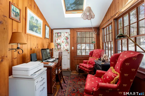 a room with furniture a chandelier and a window