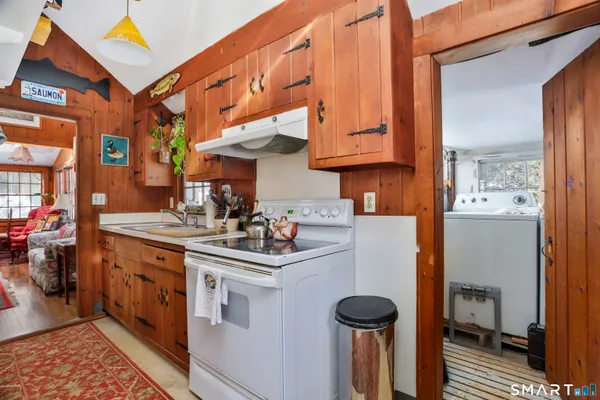 a kitchen with stainless steel appliances granite countertop a sink a stove and a refrigerator