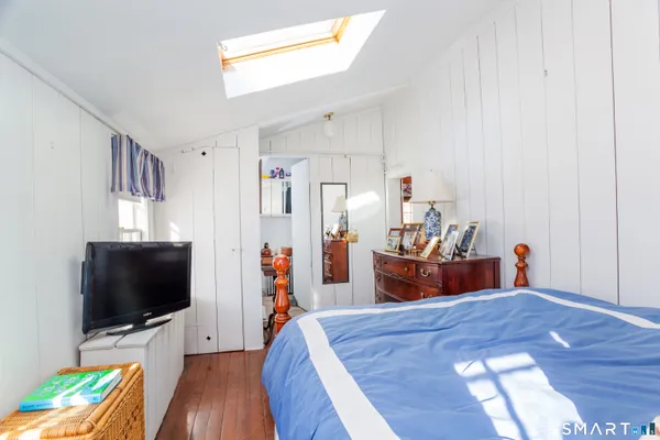 a bedroom with furniture and a flat screen tv