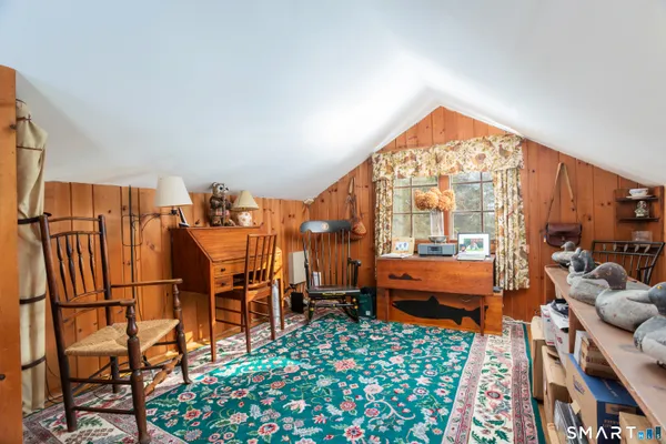 a very nice looking room with many windows and furniture