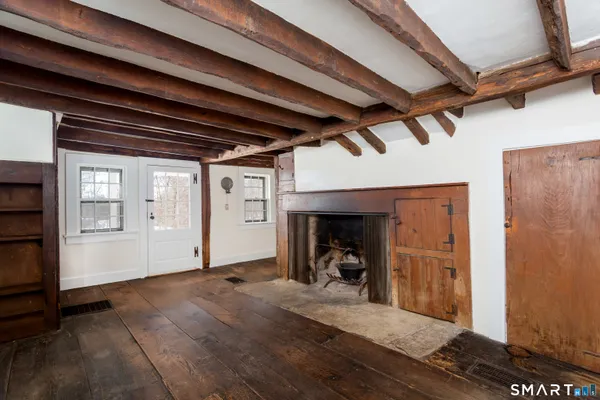a view of a livingroom with wooden floor and a sink
