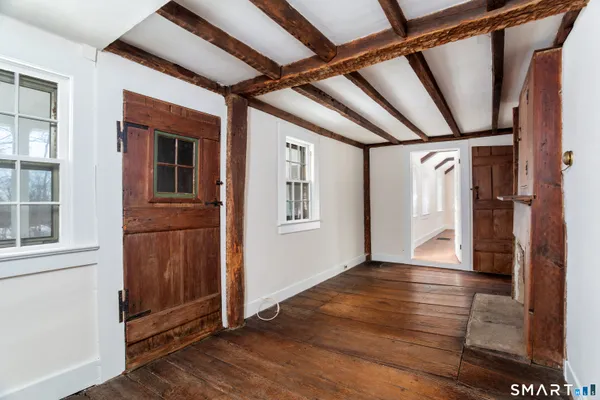 a view of an entryway with wooden floor