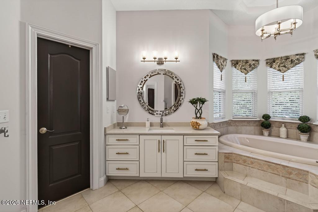 1483 Bridgette Way Fleming Island, FL 32003 - Photo 41 of 63 a spacious bathroom with a double vanity sink and a mirror