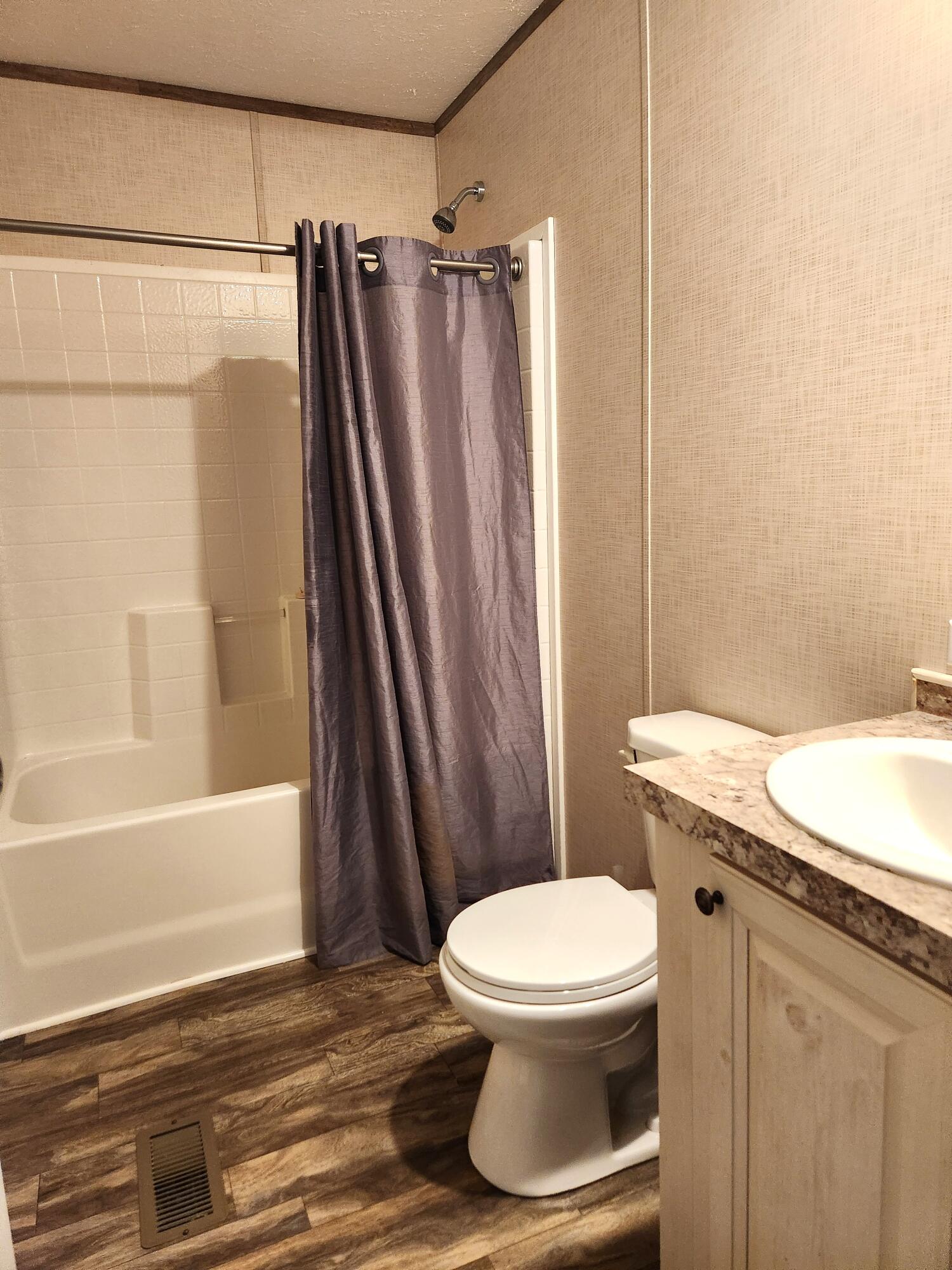 300 Whisperway Road Moneta, VA 24121 - Photo 18 of 24 a white toilet sitting next to a bath tub