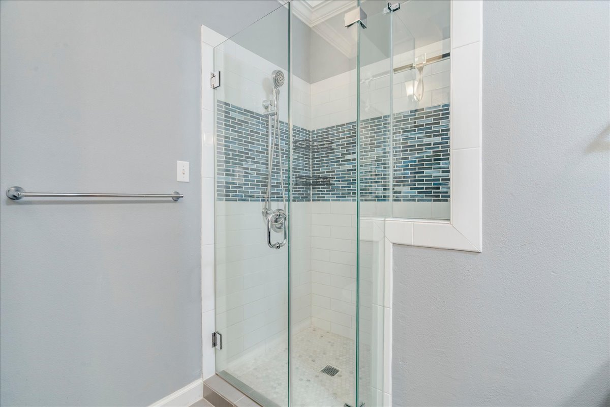 3809 Spicewood Springs Road, Unit 127 Austin, TX 78759 - Photo 15 of 29 A glass-enclosed shower boasts intricate tile work and a modern shower system.
