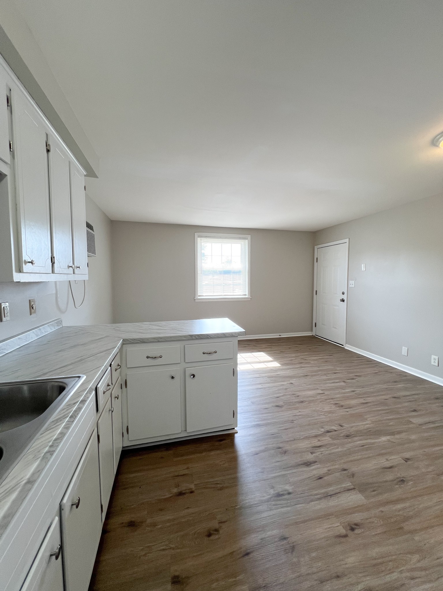 701 Power Street, Unit 4 Clarksville, TN 37042 - Photo 5 of 10 a view of a kitchen with wooden floor and electronic appliances