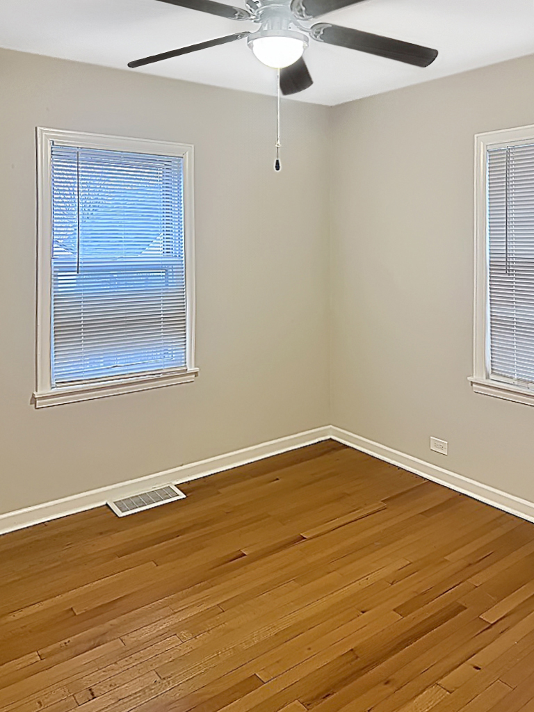 28 West 35th Place Steger, IL 60475 - Photo 12 of 20 a view of an empty room with wooden floor and a window