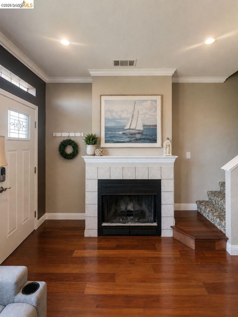3623 Wells Road Oakley, CA 94561 - Photo 8 of 59 Wood-finish flooring throughout, featuring a fireplace with a stone-tile surround and hearth