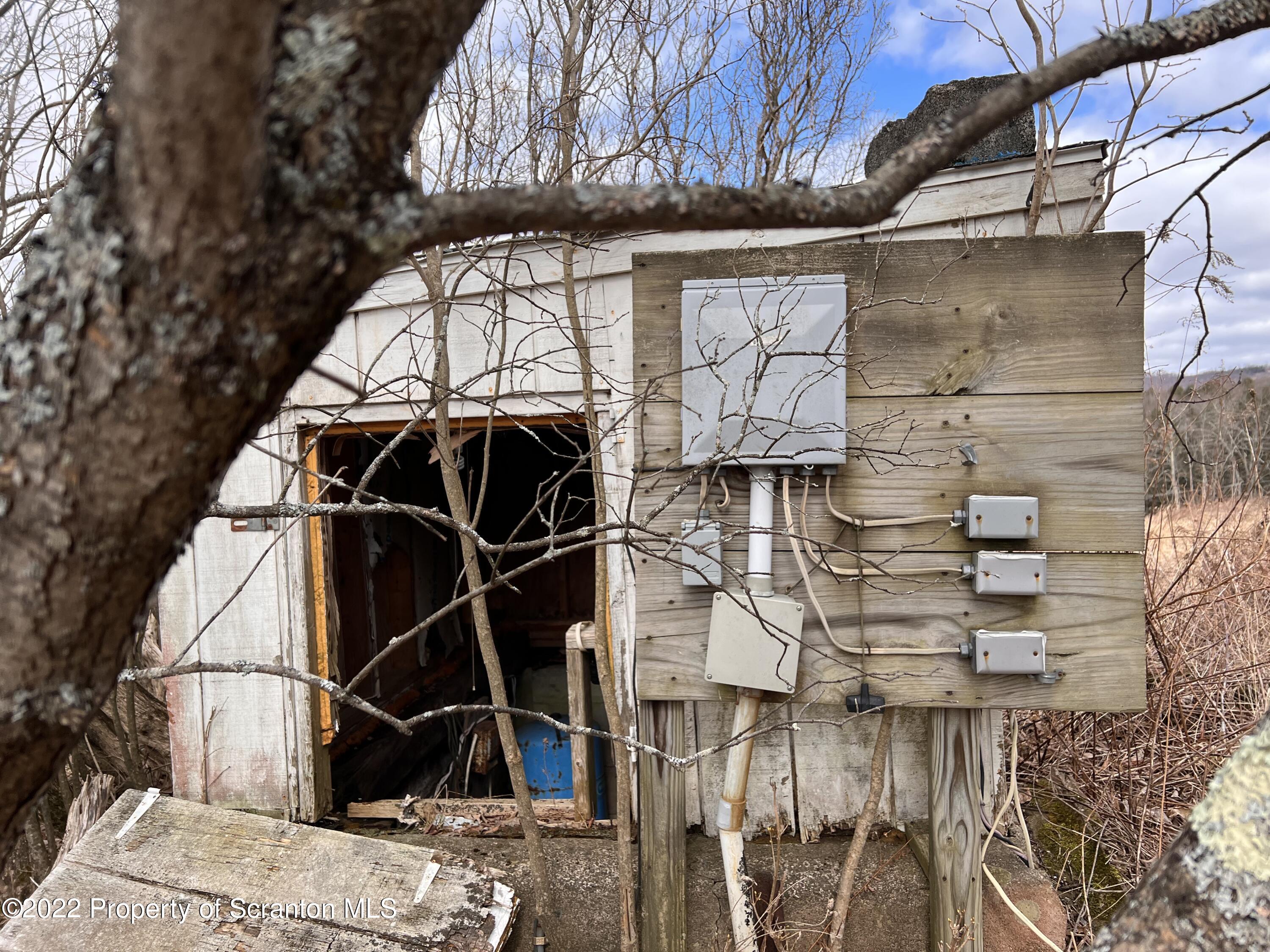 174 Upper Gelatt Road Thompson, PA 18465 - Photo 18 of 19 a view of a building with a door