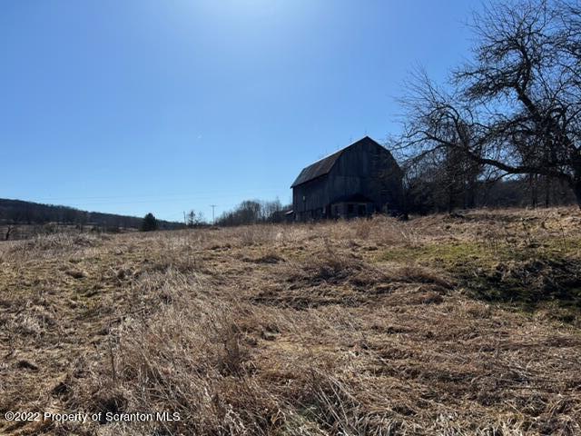 174 Upper Gelatt Road Thompson, PA 18465 - Photo 7 of 19 a view of tall trees with a mountain