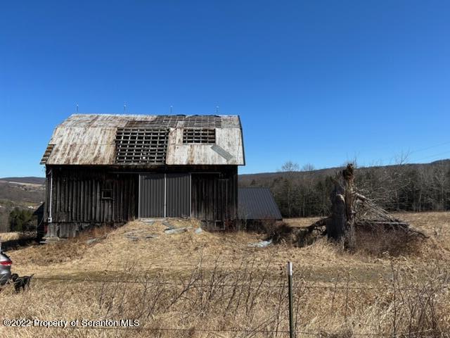 174 Upper Gelatt Road Thompson, PA 18465 - Photo 8 of 19 a front view of a house with a yard