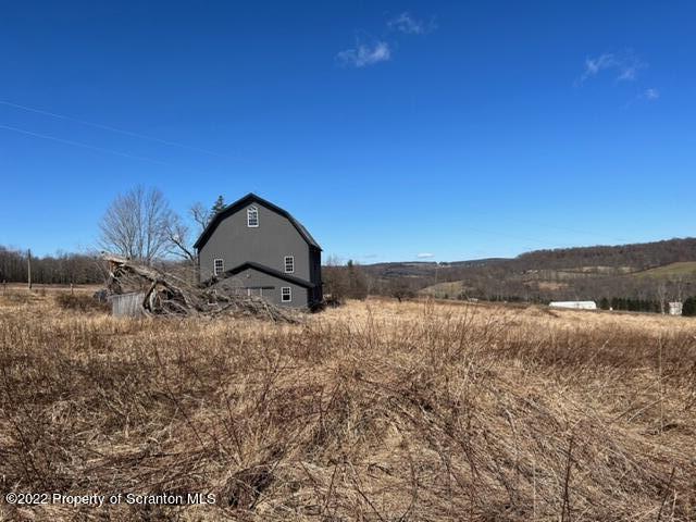 174 Upper Gelatt Road Thompson, PA 18465 - Photo 10 of 19 a view of a lake with a mountain in the background