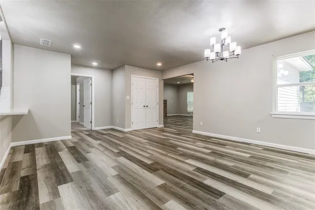wooden floor in an empty room with a fireplace