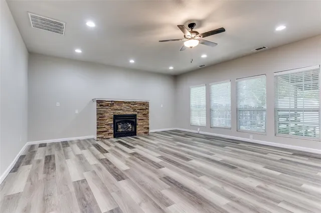 a view of a livingroom with a ceiling fan and wooden floor