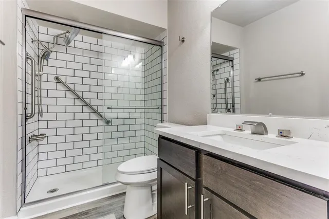 a view of a house with a yard and large tree