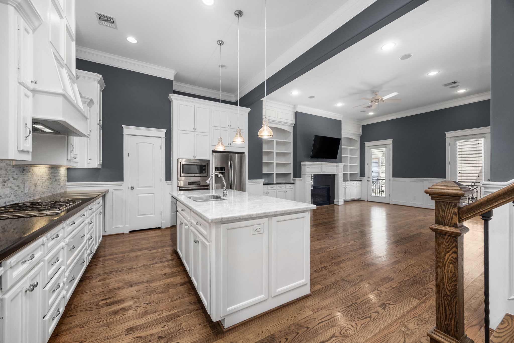 619 Rutland Street, Unit B Houston, TX 77007 - Photo 5 of 33 a large kitchen with stainless steel appliances kitchen island a large counter top a stove a chimney a sink and a refrigerator