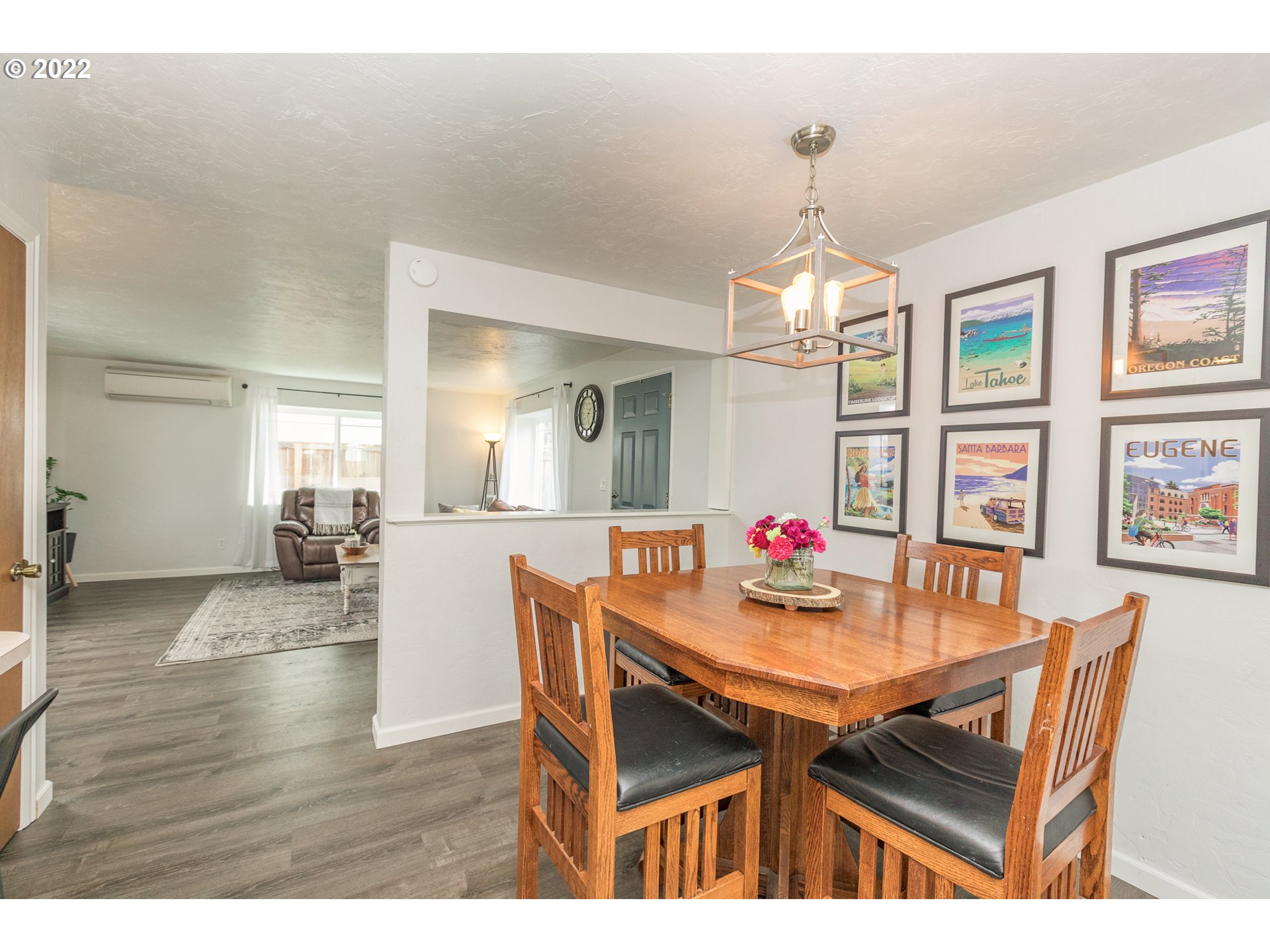 1081 South 44th Street Springfield, OR 97478 - Photo 8 of 10 a dining room with wooden floor a chandelier a wooden table and chairs