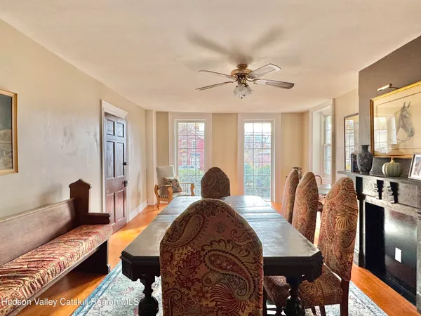 a view of a a dining room with furniture window and wooden floor