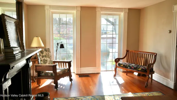 a view of an entryway with wooden floor and door