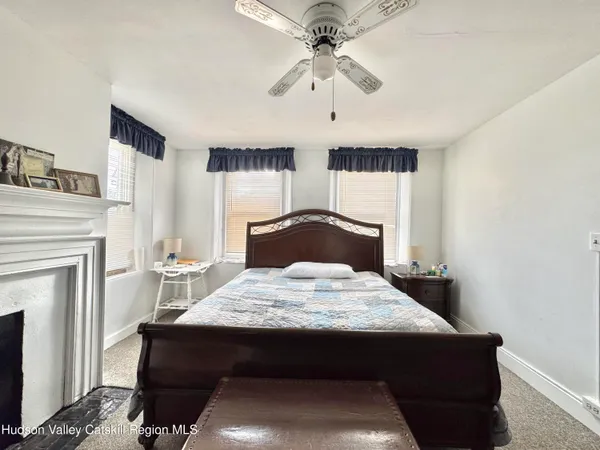 a bedroom with a bed and a fireplace