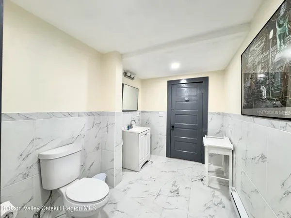 a bathroom with a toilet sink and shower