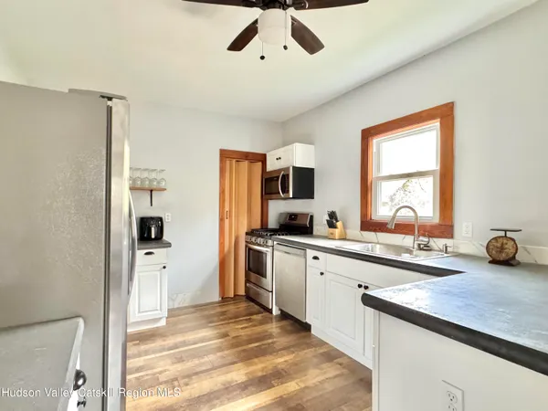 a kitchen with a sink appliances and cabinets