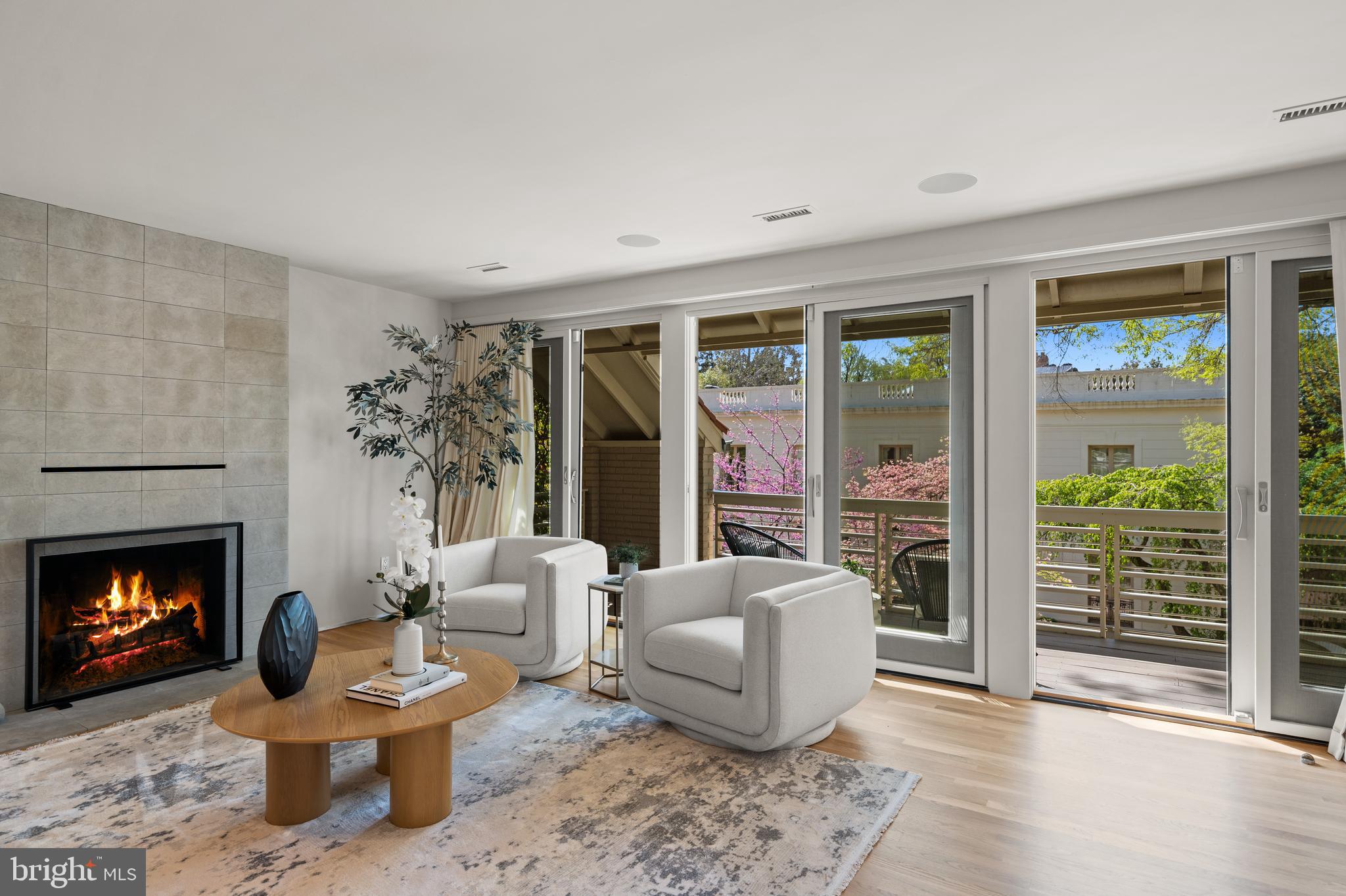 2319 Bancroft Place Northwest Washington, DC 20008 - Photo 20 of 37 a living room with furniture a fireplace and a large window