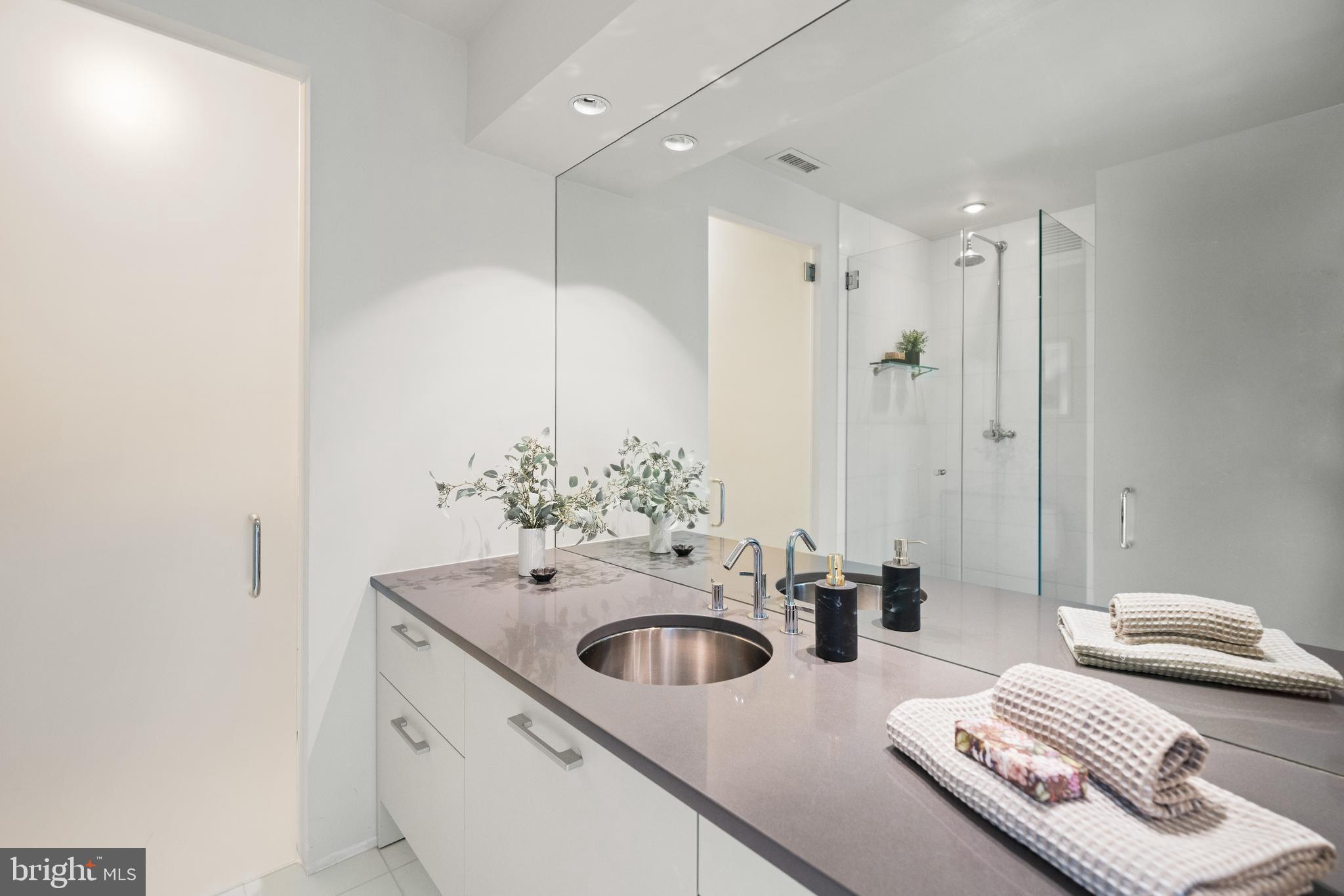 2319 Bancroft Place Northwest Washington, DC 20008 - Photo 26 of 37 a en suite bathroom with a double vanity sink and mirror