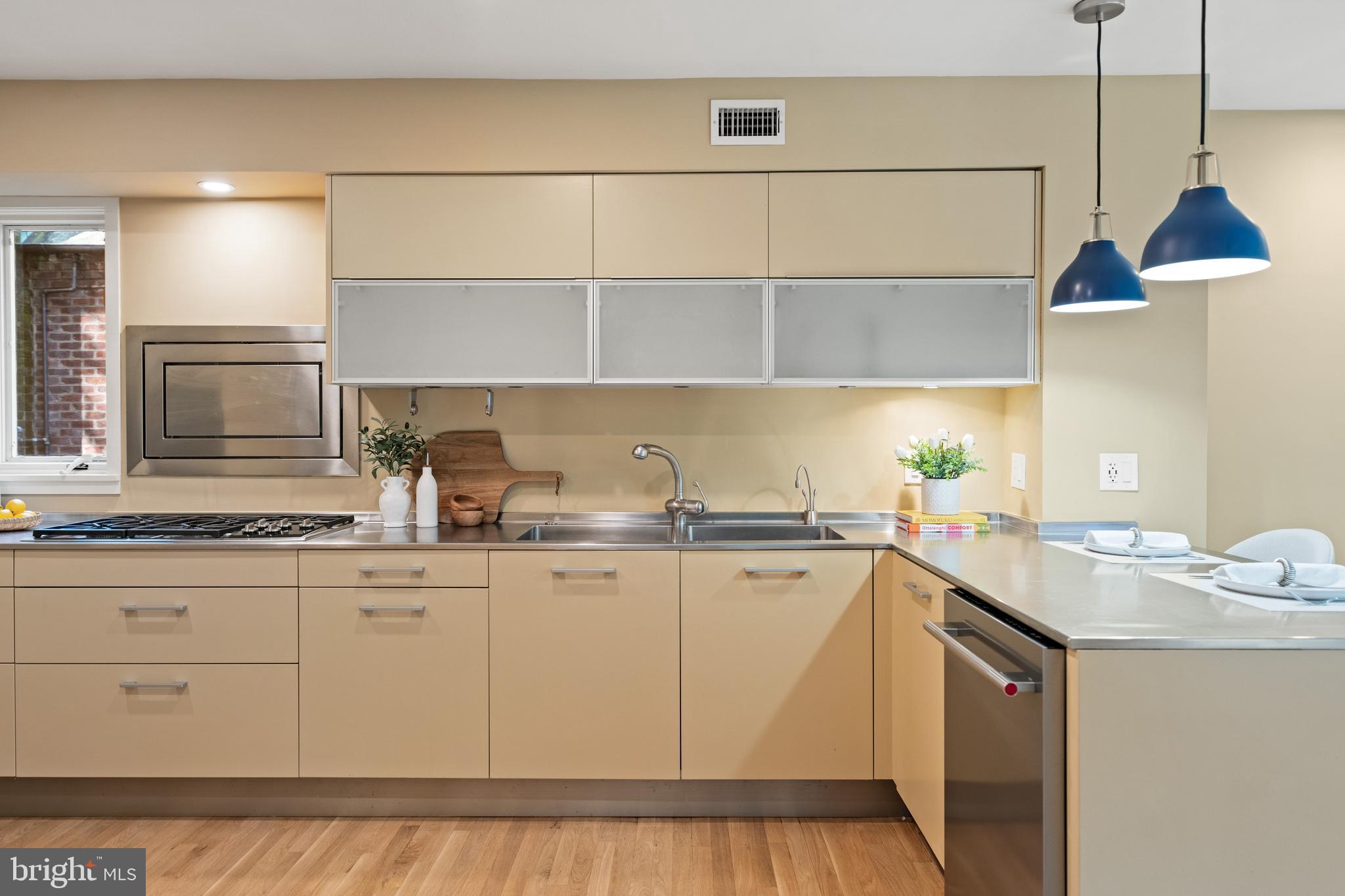 2319 Bancroft Place Northwest Washington, DC 20008 - Photo 7 of 37 a kitchen with stainless steel appliances a sink a stove and white cabinets