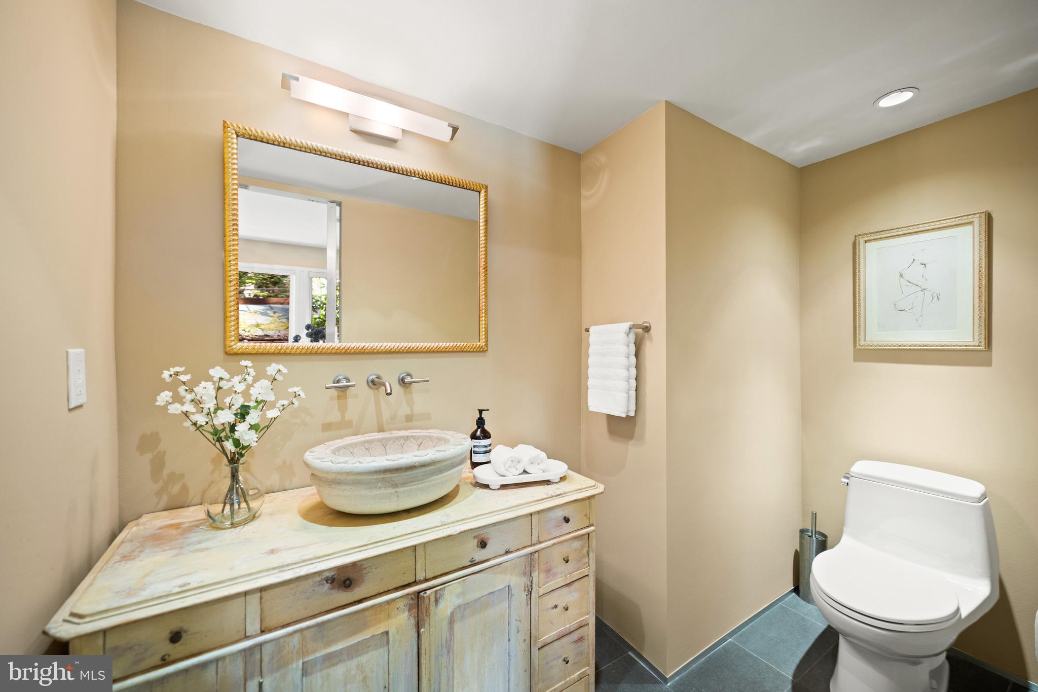 2319 Bancroft Place Northwest Washington, DC 20008 - Photo 9 of 37 a bathroom with a granite countertop sink mirror and toilet