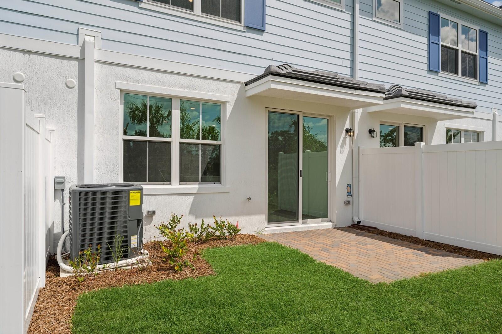188 Southeast Birch Terrace, Unit 313 Stuart, FL 34997 - Photo 27 of 30 a front view of a house with garden