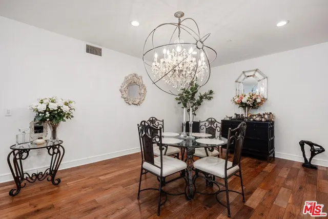 a view of a dining room with furniture wooden floor and chandelier