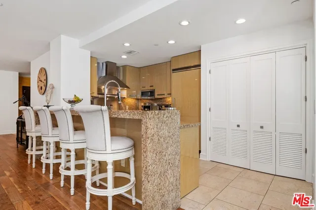 a large kitchen with dining table and chairs