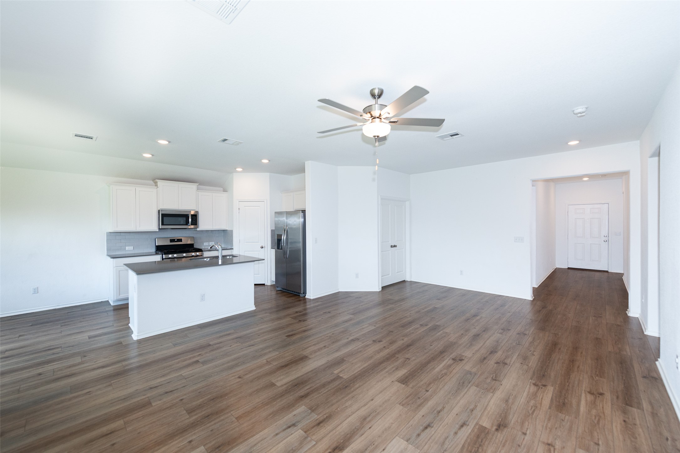 147 Otter Road Kyle, TX 78640 - Photo 10 of 34 kitchen and dining on left, entry door far right down hall