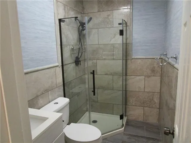 a bathroom with a toilet and a shower