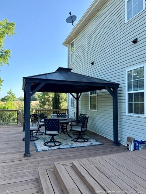 1284 L L Cooper Road Cameron, NC 28326 - Photo 18 of 24 a backyard of a house with table and chairs