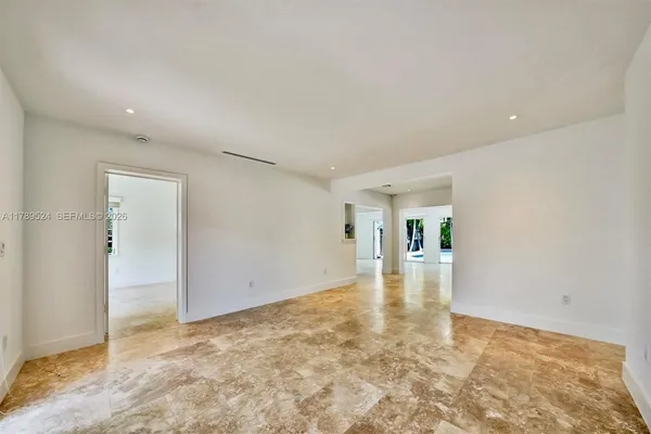 a kitchen with stainless steel appliances granite countertop a refrigerator a sink and a stove