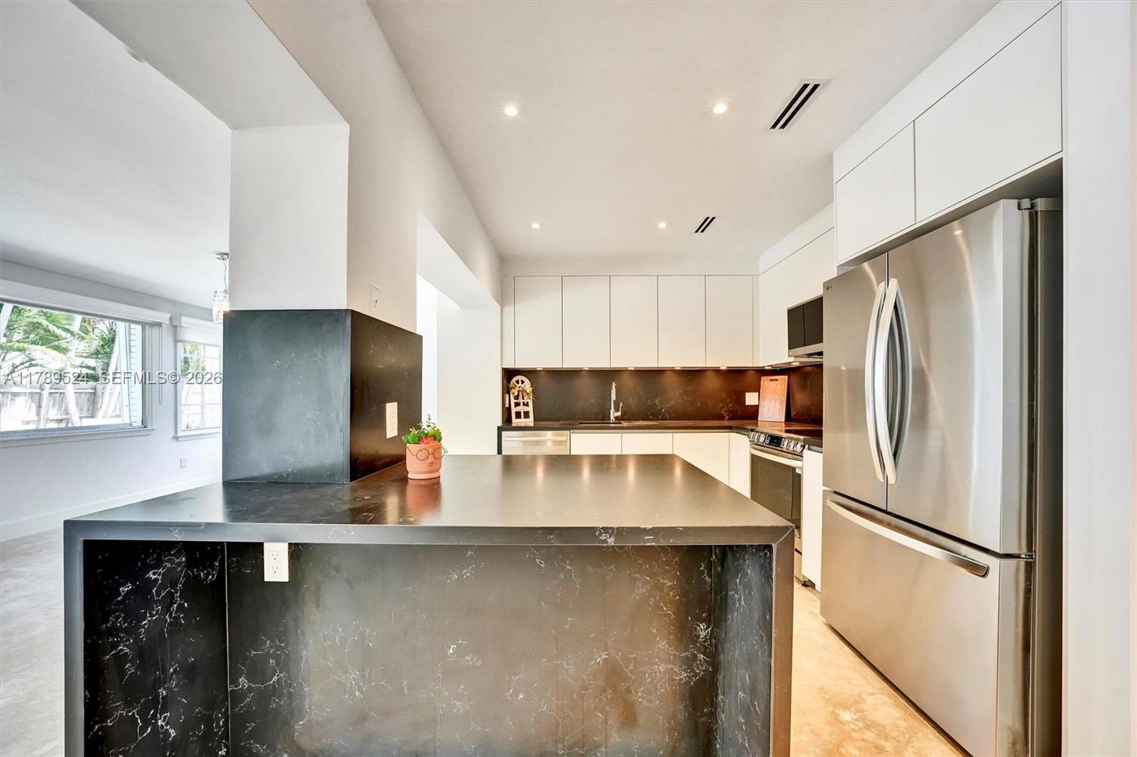 255 Ridgewood Road Key Biscayne, FL 33149 - Photo 16 of 61 a kitchen with stainless steel appliances granite countertop a refrigerator a sink and a stove