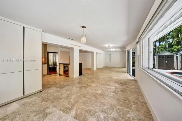 a view of room with window and a ceiling fan