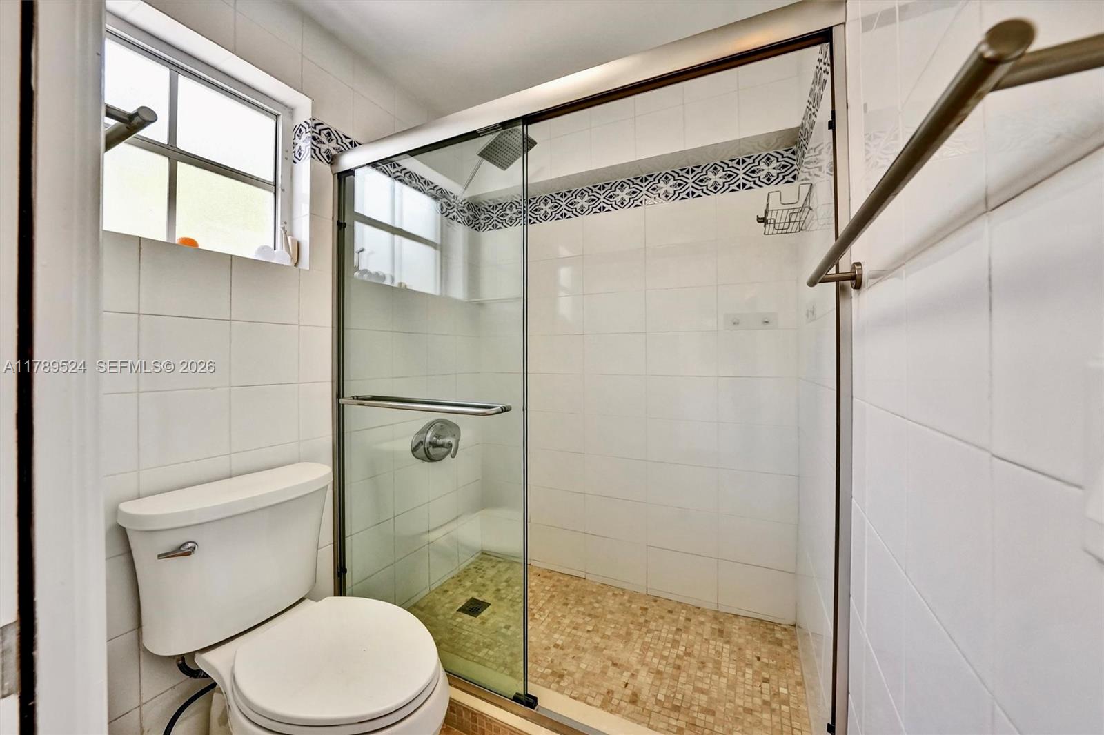 255 Ridgewood Road Key Biscayne, FL 33149 - Photo 28 of 61 a bathroom with a toilet and a shower
